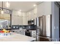 Bright kitchen featuring stainless appliances, white cabinets, subway tile backsplash, and quartz countertops at 6646 Bean Mountain Ln, Boulder, CO 80301