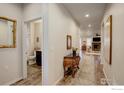 Bright hallway with hardwood floors and access to bathroom at 724 Widgeon Cir, Longmont, CO 80503