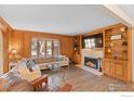 Spacious living room featuring a fireplace and built-in shelving at 819 Gapter Rd, Boulder, CO 80303