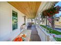 Spacious front porch with rocking chairs and hanging flower basket at 934 Larkspur Ln, Louisville, CO 80027