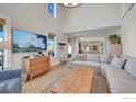 Open living room with large sectional sofa and hardwood floors at 934 Larkspur Ln, Louisville, CO 80027