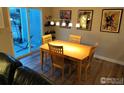 Bright dining area with wood table and chairs, and sliding glass door to patio at 9389 Garfield St, Thornton, CO 80229