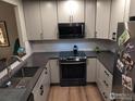 Modern kitchen with stainless steel appliances and light cabinets at 9389 Garfield St, Thornton, CO 80229