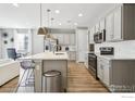 Modern kitchen featuring stainless steel appliances and an island at 9914 Truckee St, Commerce City, CO 80022