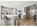 Modern kitchen with stainless steel appliances and an island at 9914 Truckee St, Commerce City, CO 80022