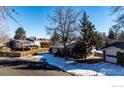 House with yard, driveway, and neighboring homes visible at 1011 Yeager Dr, Longmont, CO 80501