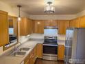 Kitchen with stainless steel appliances and wood cabinets at 1601 Great Western Dr # A7, Longmont, CO 80501