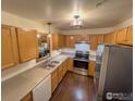 Modern kitchen with wood cabinets, stainless steel appliances, and double sink at 1601 Great Western Dr # A7, Longmont, CO 80501