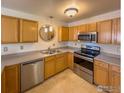 Kitchen with wood cabinets, stainless steel appliances, and granite countertops at 1601 Great Western Dr # R1, Longmont, CO 80501