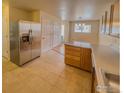 Kitchen with island, stainless steel appliances, and light wood cabinets at 1601 Great Western Dr # R1, Longmont, CO 80501