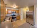 Modern kitchen, stainless steel appliances, wood cabinets at 1601 Great Western Dr # R1, Longmont, CO 80501