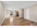 Hardwood floor living room with kitchen view at 1740 Shallot Cir, Lafayette, CO 80026