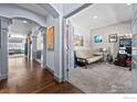 Hallway with hardwood floors and arched doorways leading to other rooms at 20356 E Shady Ridge Rd, Parker, CO 80134