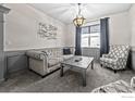 Sitting room with gray sofa, patterned chair, and a coffee table at 20356 E Shady Ridge Rd, Parker, CO 80134