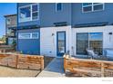 Townhome entry with modern door and wooden fence at 2446 W 167Th Ln, Broomfield, CO 80023