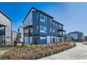 Stylish townhome with blue siding and landscaping at 2446 W 167Th Ln, Broomfield, CO 80023