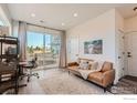 Cozy living area with a comfortable couch, large sliding glass doors, and natural light at 2446 W 167Th Ln, Broomfield, CO 80023