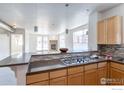 Kitchen with breakfast bar and gas cooktop at 2850 E College Ave # 402, Boulder, CO 80303