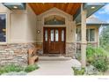 Inviting entryway with stone accents and wood door at 309 Sunrise Ln, Boulder, CO 80302