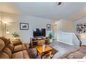 Cozy living room featuring comfortable seating, a television, and neutral decor at 413 Canyonlands St, Berthoud, CO 80513