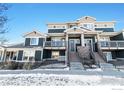 Modern two-story townhome with stone accents and balconies at 543 Brennan Cir, Erie, CO 80516