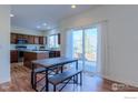 Kitchen with an adjacent dining area and sliding glass door access to the patio at 614 Americana Rd, Longmont, CO 80504