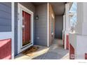 Inviting front entrance with red door and a welcoming stoop at 614 Americana Rd, Longmont, CO 80504