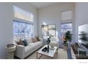 Bright living room with large windows, comfy sofa, and stylish coffee table at 614 Americana Rd, Longmont, CO 80504