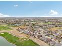 Wide aerial view of a neighborhood near a golf course and lake at 8027 Tamarac Ct, Thornton, CO 80602