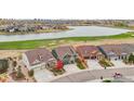 Community overview featuring houses, lake, and golf course at 8027 Tamarac Ct, Thornton, CO 80602