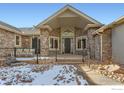 Inviting front entrance with stonework and covered porch at 8777 Comanche Rd, Niwot, CO 80503