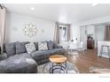 Open concept living room with sectional sofa and dining area at 8861 Hastings Way, Westminster, CO 80031