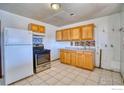 Simple kitchen with wood cabinets and appliances at 940 E 89Th Ave, Thornton, CO 80229