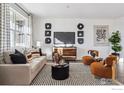 Living room featuring a neutral color palette, comfortable seating and a large TV at 948 Andrews Crest Dr, Berthoud, CO 80513