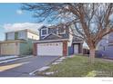 Two-story home with brick and gray siding, white garage door, and a small front yard at 11562 Depew Ct, Westminster, CO 80020