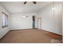 Bright dining room with vaulted ceiling and carpet flooring at 1434 Hickory Dr, Erie, CO 80516