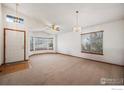 Spacious living room featuring bay window and vaulted ceiling at 1434 Hickory Dr, Erie, CO 80516