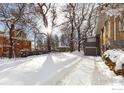 Snowy backyard with tire tracks and trees covered in snow at 1520 Baseline Rd, Boulder, CO 80302