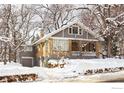 Two-story home with gray and yellow exterior, covered in snow at 1520 Baseline Rd, Boulder, CO 80302