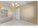 Bright dining area with tiled floor and view into living room at 1537 Hilltop Dr, Longmont, CO 80504