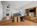 Home office with wood desk and built-in shelving at 2062 Indian Paintbrush Way, Erie, CO 80516