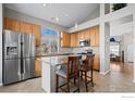 Spacious kitchen with granite island and stainless steel appliances at 2062 Indian Paintbrush Way, Erie, CO 80516