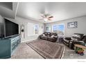 Spacious living room with brown leather furniture and a large TV at 344 Ellie Way, Berthoud, CO 80513