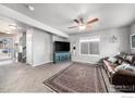 Living room with brown leather furniture, large TV, and entryway at 344 Ellie Way, Berthoud, CO 80513