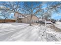 Two-story townhome with two-car garage and snowy yard at 421 Stevens Cir, Platteville, CO 80651