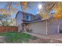 Townhome with attached garage and autumn leaves at 421 Stevens Cir, Platteville, CO 80651