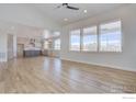 Bright living room featuring hardwood floors and large windows with backyard views at 497 Muirfield Cir, Louisville, CO 80027