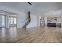 Open-concept living space with hardwood floors and views into the kitchen at 497 Muirfield Cir, Louisville, CO 80027