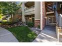 Brick and siding condo building with stairs and landscaping at 8400 S Upham Way # E5, Littleton, CO 80128