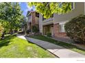 Landscaped walkway leading to condo building entrance at 8400 S Upham Way # E5, Littleton, CO 80128